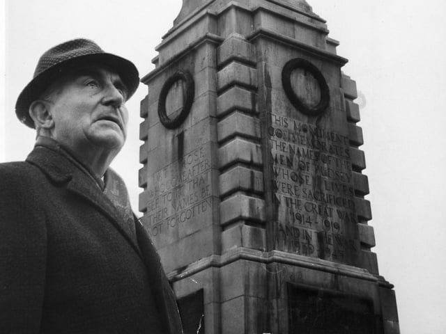Councillor Fred Ambler stands beside the town's war memorial on Church Lane which at the time he claimed was in 'urgent need' of a clean up.