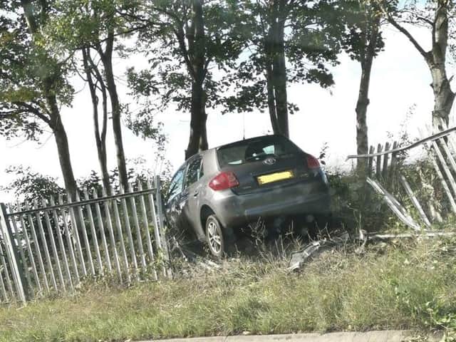 A car veered off the road before smashing through a fence. cc WYPRPU