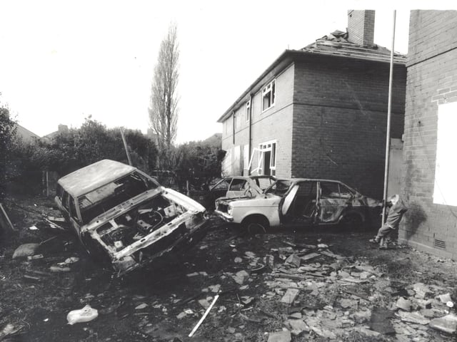 Burned out cars litter a back garden in Casterton Gardens in Seacroft.