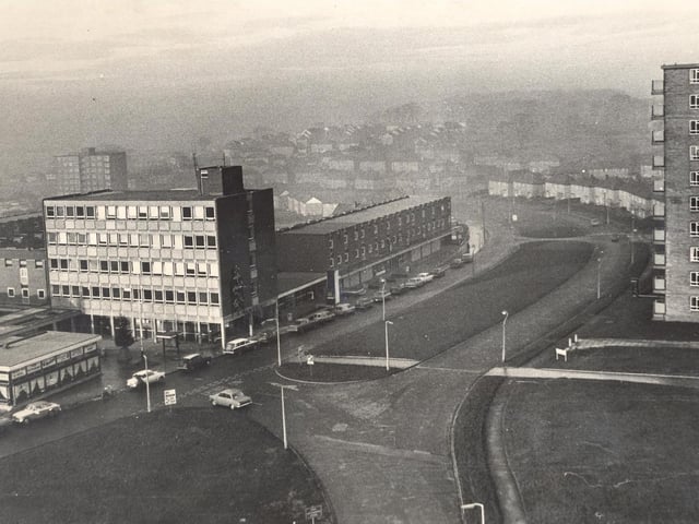 A bird's eye view which many people get from their lofty flats near the shopping centre - block upon block of council houses disappear into the winter mist.