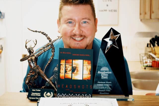 Leeds man Chris O'Neill with his awards and copy of his film Headshots.