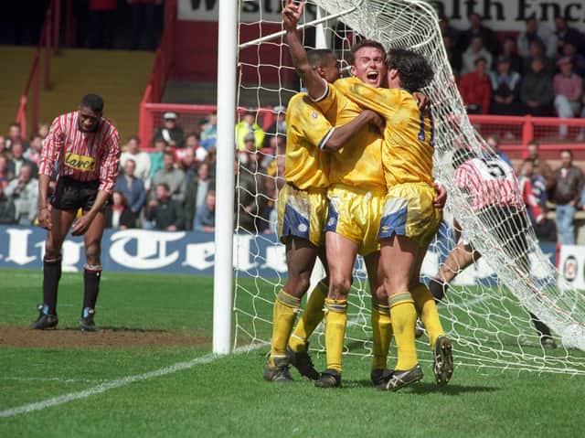 CRUCIAL GOAL: Brian Deane looks on dejected as Jon Newsome, centre, Chris Fairclough, left, and Garry Speed celebrate Newsome's header that put Leeds United 2-1 up and on course for a 3-2 victory at Sheffield United in April 1992, a victory which bagged Howard Wilkinson's side the First Division championship.