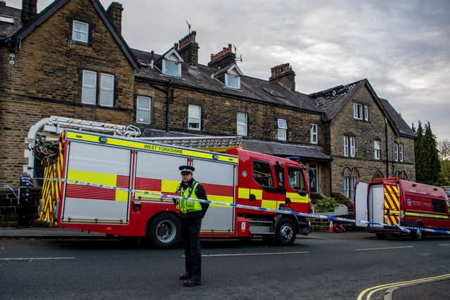 Fire fighters dampen down at the scene of a fatal house fire in Ilkley on Thursday.