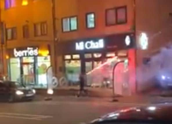 Still from the footage showing a man carelessly launching an exploding firework over his shoulder in a street in Bradford. Picture: Khalid Fuz/UK Plate Spotter