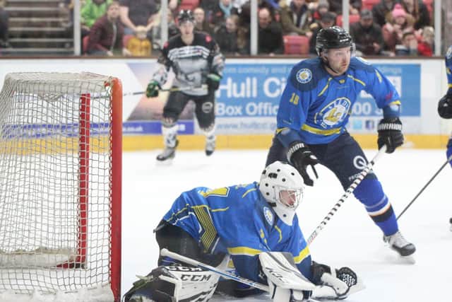Sam Gospel covers up as defenceman Richard Bentham keeps an eye out for danger. Picture courtesy of Lois Tomlinson.