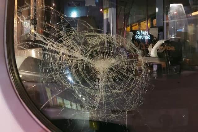 The smashed windscreen of the bus.