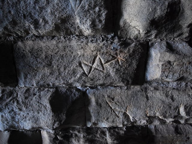 The symbols and marks on the walls are intriguing.