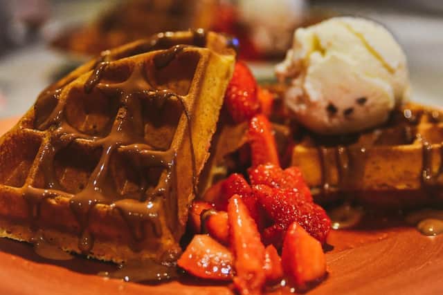 The menu includes a range of pancakes, waffles, fondants, cakes and artisan slices