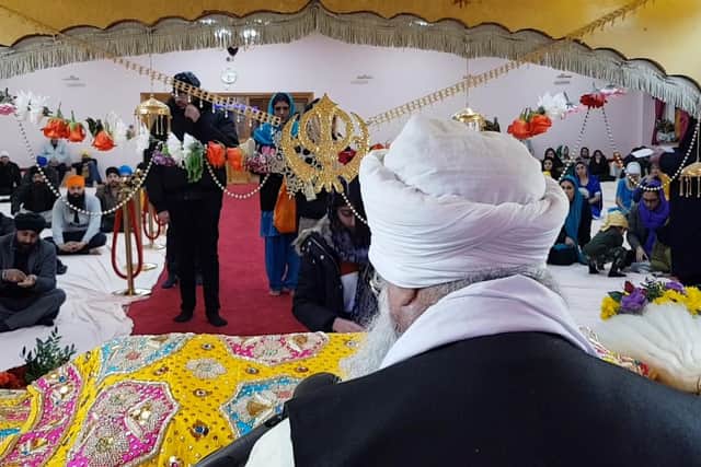 Worshippers bring food and donations to The Sikh Temple as they mark the 550th anniversary of the founder of Sikhism.