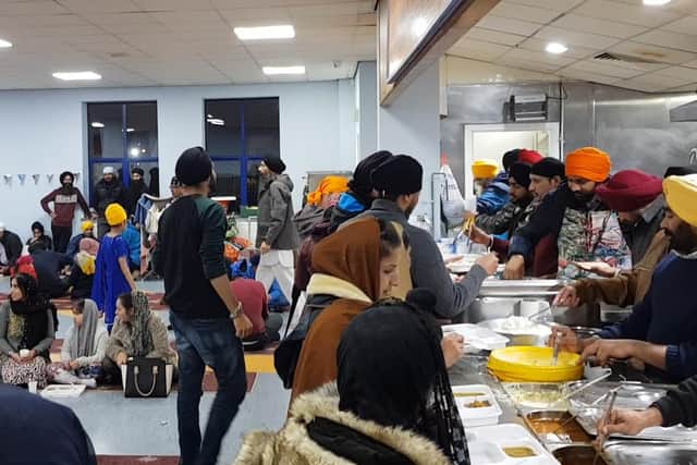 The Langar is a hive of activity as the community dine together.