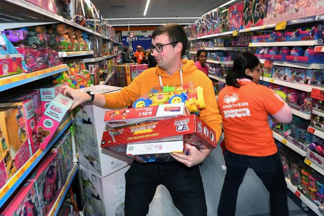 Trolley dash for Radio Aire's Mission Christmas toy appeal with breakfast show presenters Michael Blades & Katy Poulson at B&M in Kirkstall.
Picture : Jonathan Gawthorpe