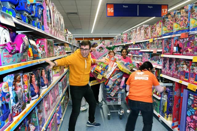 Trolley dash for Radio Aire's Mission Christmas toy appeal with breakfast show presenters Michael Blades & Katy Poulson at B&M in Kirkstall.
Picture : Jonathan Gawthorpe