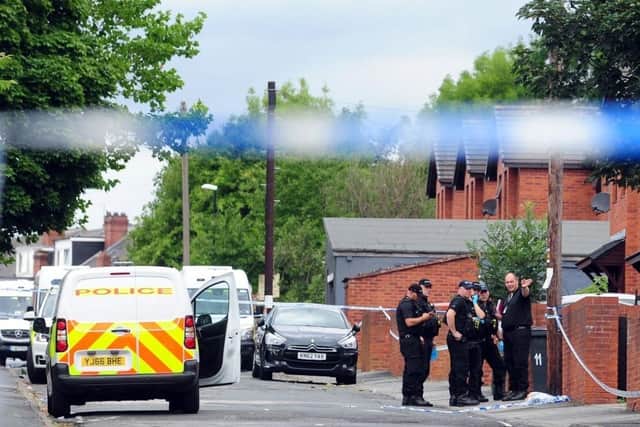 Police at the scene of Christopher Lewis's murder in Chapeltown.