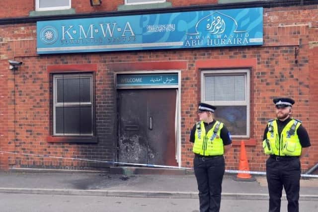 Police stand guard outside the mosque's former base in Hardy Street after an arson attack in 2018.