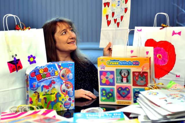 Claire Baskind, from Leeds, with some of the gifts and toys that will be presented to children at Leeds General Infirmary and St James' Hospital this Christmas. Image: Gary Longbottom.