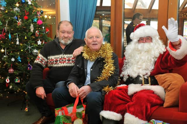 Santa Claus with Emmerdale stars Joshua Richards (left) and Chris Chittell at   Martin House Hospice at Boston Spa  during his visit by helicopter.
