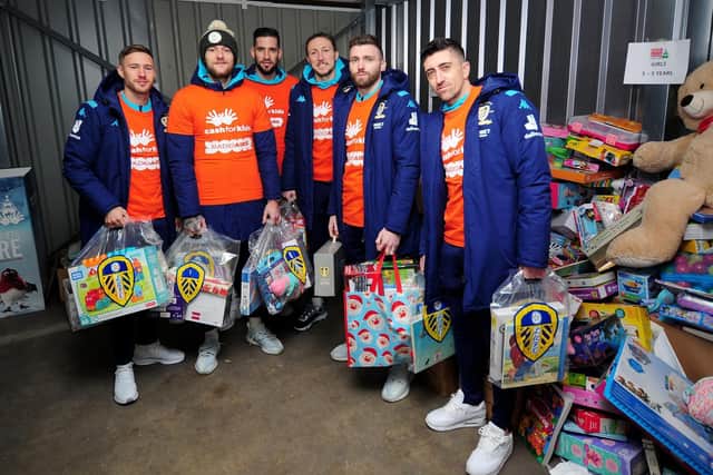 SANTA'S WHITES ELVES: Left to right, Leeds United players Barry Douglas, captain Liam Cooper, Kiko Casilla, Luke Ayling, Stuart Dallas and Pablo Hernandez drop off gifts as part of the Radio Aire Cash For Kids Mission Christmas appeal. Picture by Simon Hulme.
