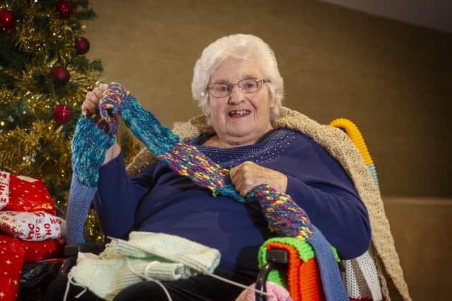 88-year-old Brenda Horsfall has gathered over 100 knitted scarves for her friends at Sunnyview Bupa Care Home, Manorfield, Beeston, Leeds, where she lives, and recieved knitting squares from across the globe to stitch together for the cause. Picture Tony Johnson