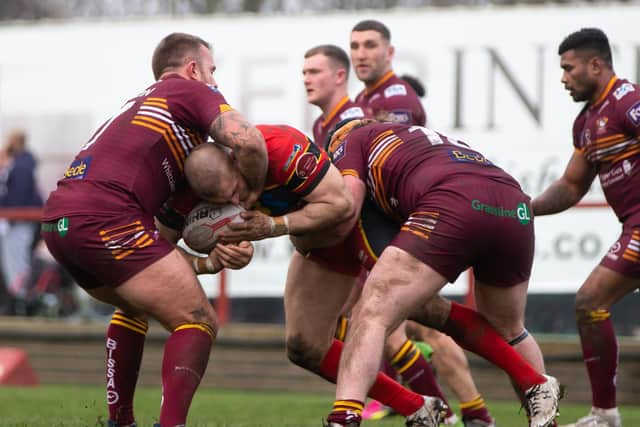 Adam Ryder is wrapped up during last year's Boxing Day Challenge at Batley.