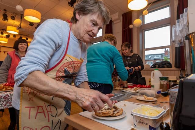 Doreen Cheetham, preparing a snack for a visitor to the morning cafe session.
