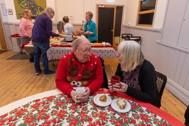 Michael Hassell, and Rosie Nadin-Pummell, who both volunteer for the be-friending service with OWLS have a chat at the HEART community cafe in Headingley.