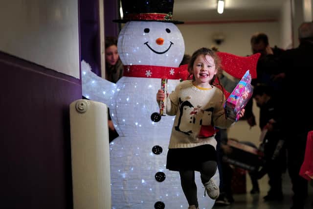 Parklands Primary School, Seacroft, Leeds, is holding a Christmas Eve Party for Underpriviledged children. Scarlett Manson aged 5 is excited after meeting Santa and getting a present. Picture by Simon Hulme