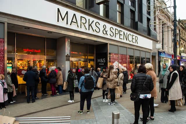 Shoppers in Leeds waiting to get in to the Marks & Spencer department store on Briggate.