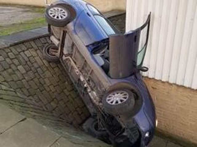 Car gets stuck down walled ditch while trying to get away from West Yorkshire Police officers. Picture: Twitter/@WYP_PCWILLIS