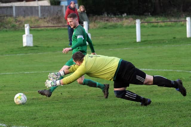 Matty Moon scores the second goal for Beeston St Anthony's  in the 2-0 win over Robin Hood.