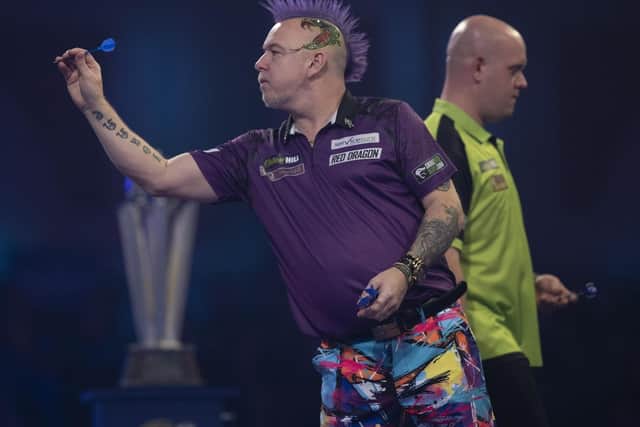 Peter Wright in action against Michael Van Gerwan in the final of the PDC World Darts Championship. Picture: Lawrence Lustig.