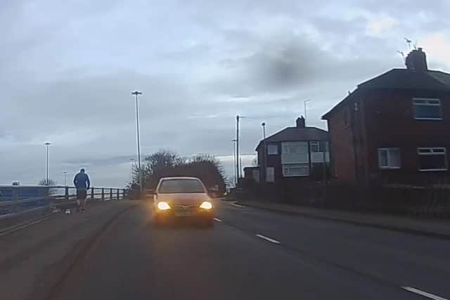 Video footage shows the car almost striking the cyclist