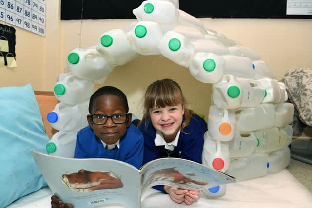 Pupils Immanuel and Lucy in an igloo that forms part of the Arctic display at Sharp Lane Primary School.