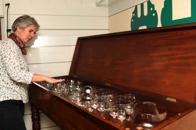TUNEFUL: Curator Kitty Ross tries out the glass harp.