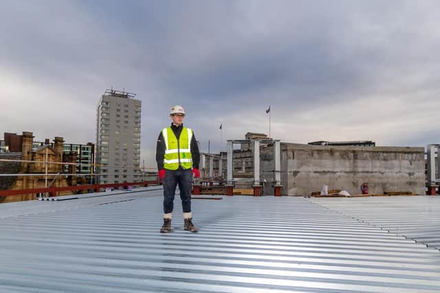 Eddy Bryan, graduate engineer for Sir Robert McAlpine looking at the construction progress to date.