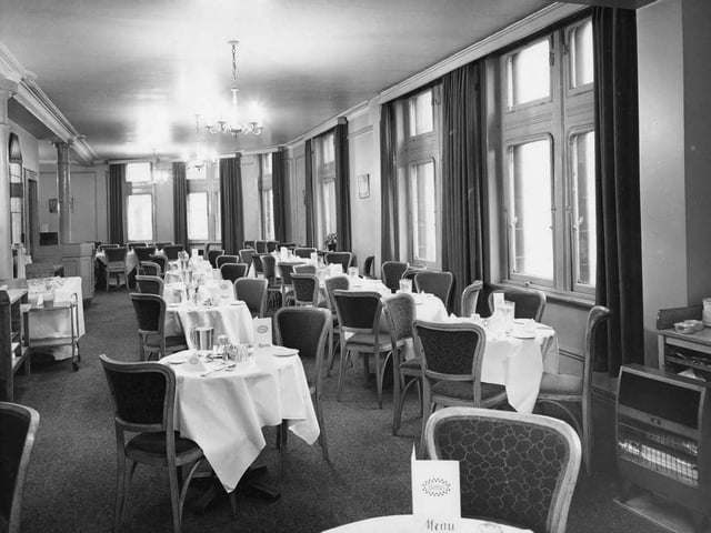 The first floor cafe, serving morning coffee afternoon tea and light lunches, was decorated in an ivory and blue colour scheme with blue-tinted mirrors.