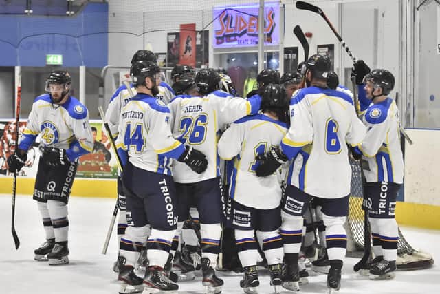 Leeds CHiefs' players surround netminder Sam Gospel after their shootout win in Telford. Picture courtesy of Steve Brodie.