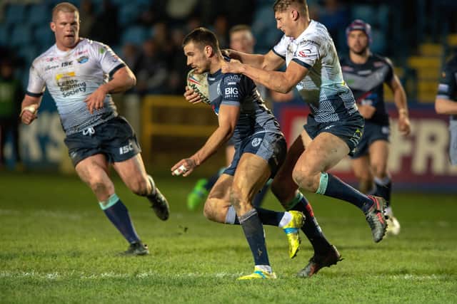Leeds' Sam Walters hitches lift aboard Gareth Gale of Featherstone Rovers.