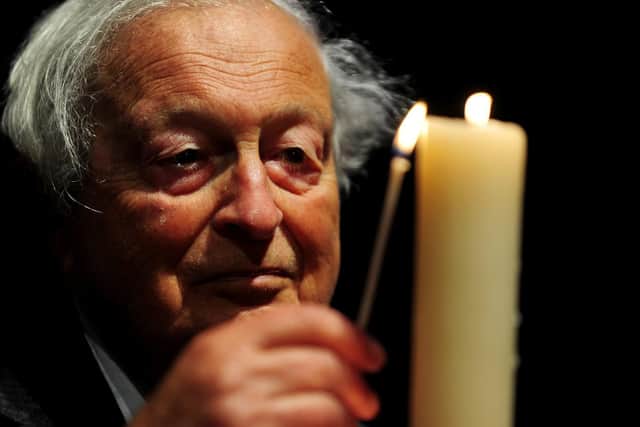 Dr Rudi Leaver lights a candle at Leeds Town Hall, as part of the Holocaust Memorial Day.Picture by Simon Hulme.