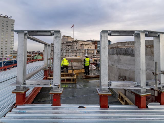 Construction workers working on the roof on the Majestic.