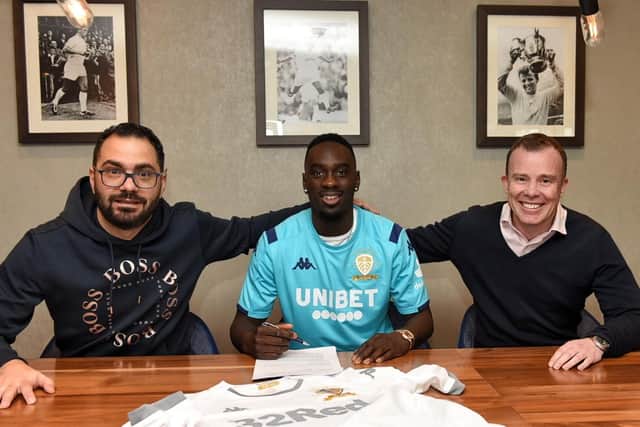 R-L: Victor Orta, Jean-Kevin Augustin and Angus Kinnear at Elland Road today, when the transfer was completed
