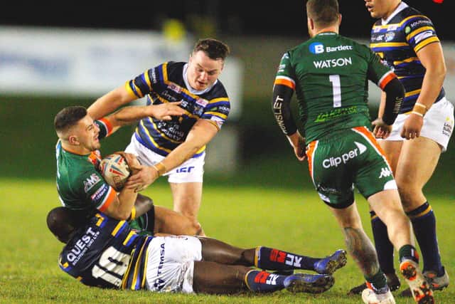 Hunslet's Vila Halafihi tackled by Muizz Mustapha and Loui McConnell. Picture by Craig Hawkhead.