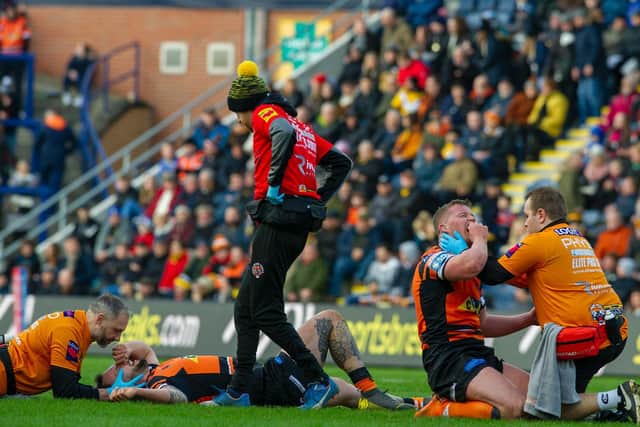 Tigers' George Griffin (left) and Adam Milner are treated after a clash of heads. Picture by Tony Johnson.