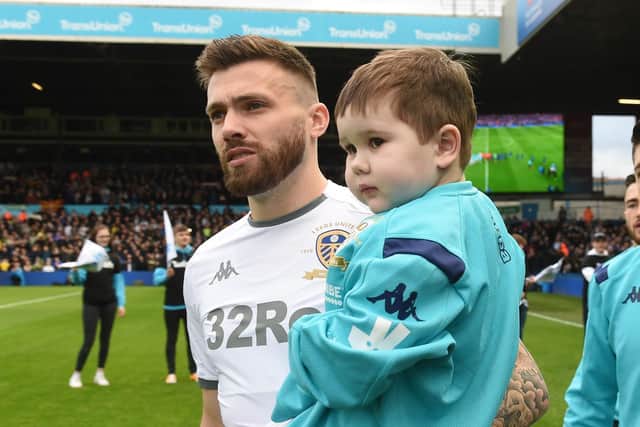 Eddie Franks walking onto the pitch at Elland Road with Adam Forshaw.