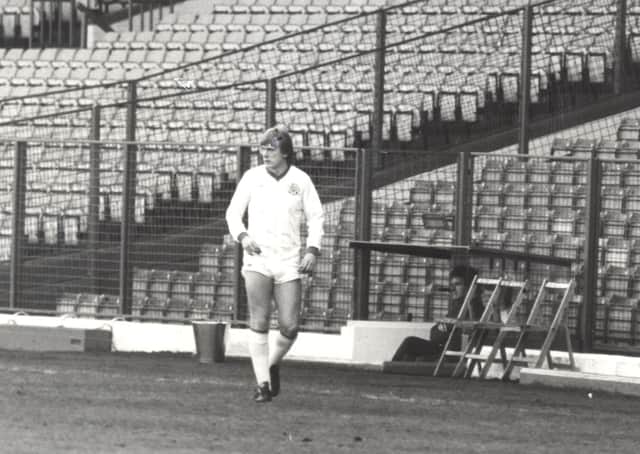Peter Barnes cuts a lonely figure in the shadows of the empty terraces at Elland Road.