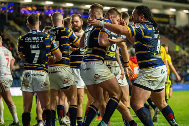 Jack Walker celebrates with team-mates after scoring the Rhinos' fourth try against Hull KR.