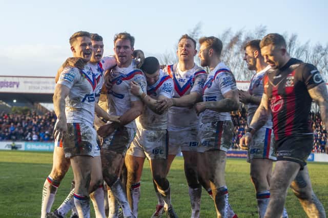 Wakefield's Matty Ashurst celebrates his try with his team mates. Picture Tony Johnson