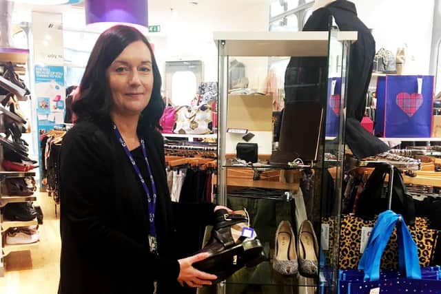 Karen Prudhoe, of Cancer Research UK's Leeds city centre shop, with the odd-sized Burberry boots.