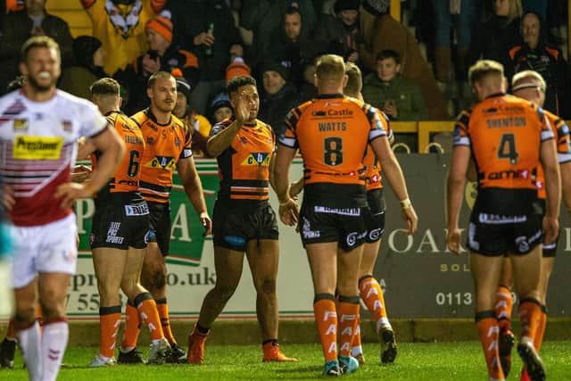 Derrell Olpherts (third Castelford player from left) celebrates his try in the home win over Wigan. Picture by Bruce Rollinson.