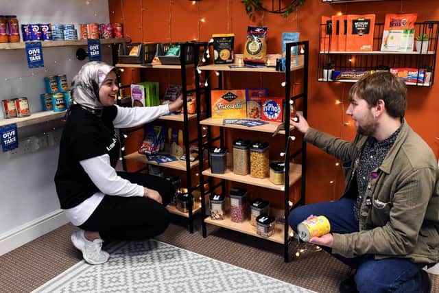 Student volunteers Menna Wahab (left) and Matthew Morris stocking up the student foodbank near to The Hive at Leeds Beckett University.