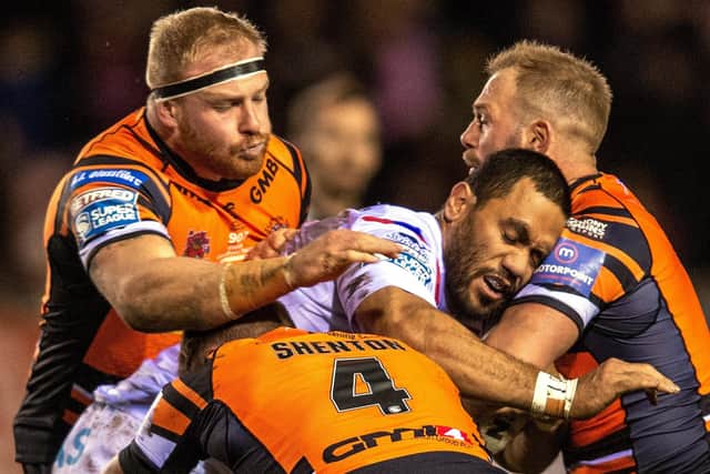 Oliver Holmes, left, leads Castleford's defensive effort in his 200th game for the Tigers with team-mates Paul McShane and Michael Shenton. PIC: Bruce Rollinson/JPIMedia